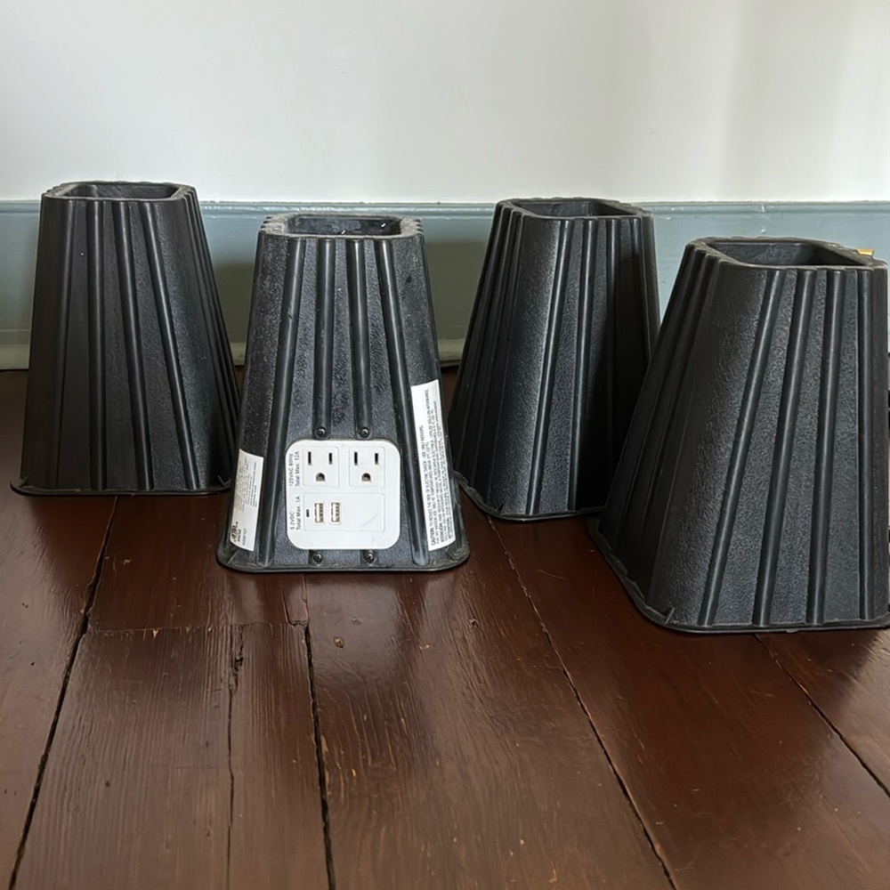 Bed risers with electrical plugs